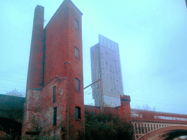 Old brick warehaouse with Hilton Hotel glass tower in background
