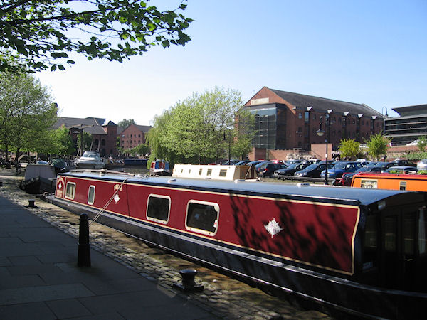 Narrowboat moored in sunshine in Castlefields Basin