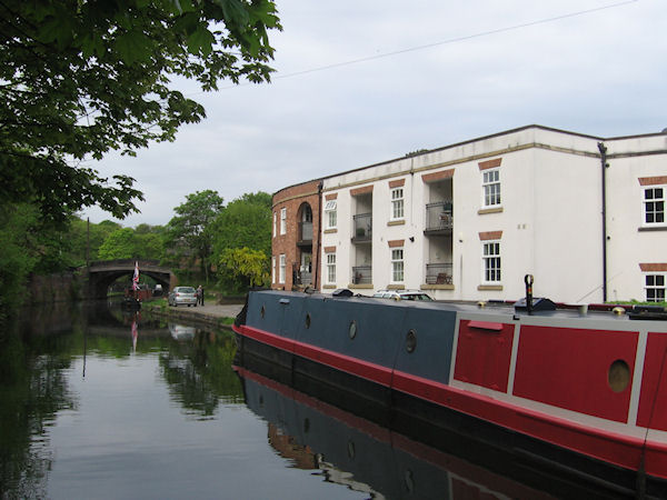 Narrowboat moored outside two storey apartments