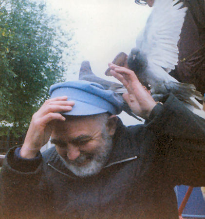 Dad feeding pigeons with his hat!